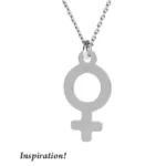 Silverberlock Kvinnosymbol är ett silverhalsband med en Venus-symbol som hänge på en kedja. "Inspiration!" står i svart kursiv stil i det nedre vänstra hörnet.