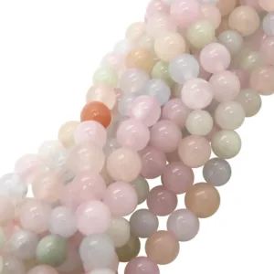 Närbild av flera trådar med Karneol rund ädelsten enfärg 4-6 mm pärlor i mjuka pastellfärger - rosa, ljusgrön, ljusblå, vit - och en orange pärla som sticker ut, alla tätt ihop.