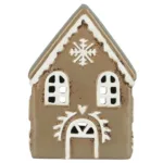 Pepparkakshus för ljus med snökristall är ett litet hus i keramik med snöflingor ovanför den välvda dörren, vita detaljer och fönsterutskärningar som påminner om ett pepparkakshus.