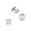 Three clear faceted glass beads scattered on a white background.