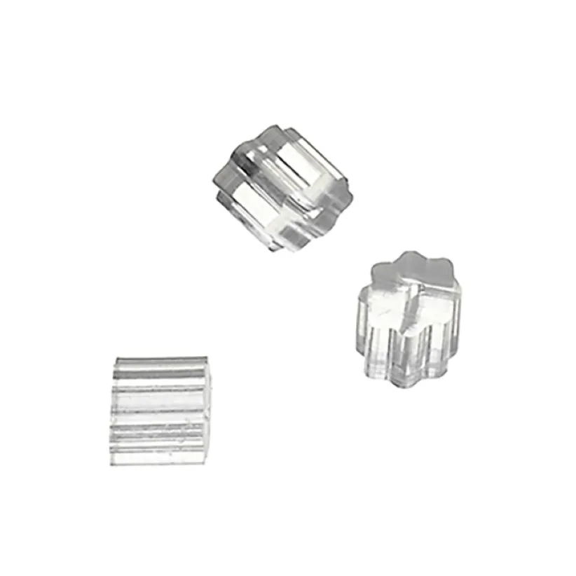 Three clear faceted glass beads scattered on a white background.