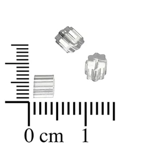 Three clear plastic spacer beads next to a centimeter ruler, showing they are about 0.5 cm in size.