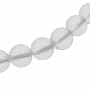 Close-up of a string of white translucent round beads on a necklace.