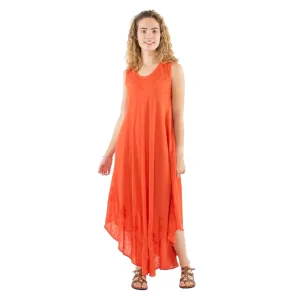 Woman wearing an orange sleeveless maxi dress with lace detailing, standing and smiling in sandals.