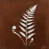 White fern leaf cutout on a textured, rusted metal surface.
