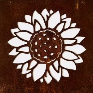 Close-up of a white floral cutout (lotus-like) against a rusted metal surface, showing intricate petals and dotted center pattern.
