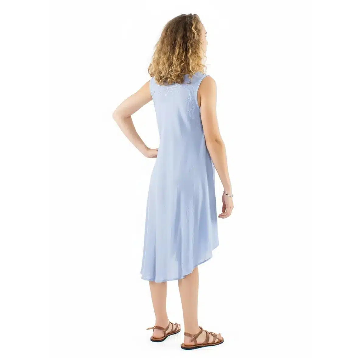 Back view of a woman wearing a light blue sleeveless midi dress, with curly hair and brown sandals.