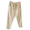 Beige casual jogger pants with a drawstring waist and rolled cuffs at the ankles, front pockets visible.