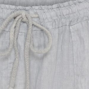 Close-up of light gray fabric with a braided drawstring tied in a knot.