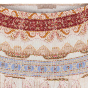 Close-up of a quilted textile with colorful, wavy stripes in pink, orange, yellow, and blue tones.