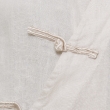 Close-up of white fabric with a small beige drawstring tied in a knot along a seam