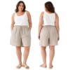 Front and back view of a woman wearing a white sleeveless top, beige drawstring linen shorts, and beige sandals against a black background.
