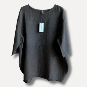 Dark gray linen blouse with a light blue tag attached at the neckline, long sleeves, and a curved hem visible on a neutral background.